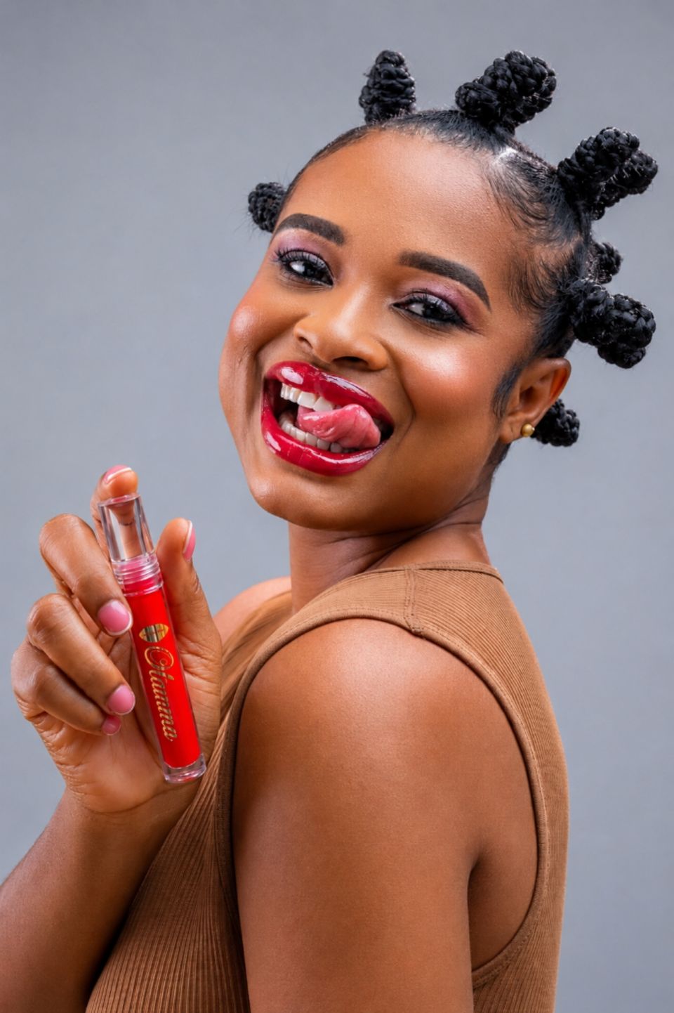 Model holding the Ugo tube beside her red glossy lips