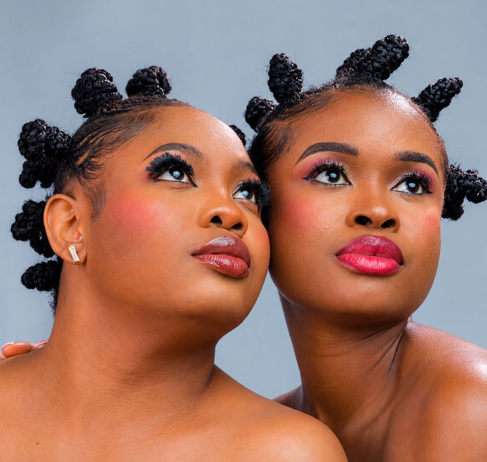 Two friends in bantu knots wearing pink gloss